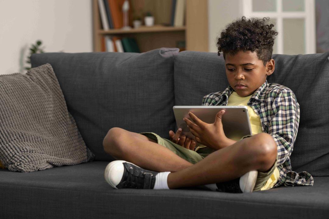 Child looking bored at a screen